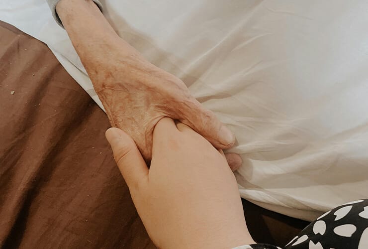 Elderly couple holding hands